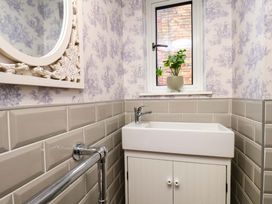 A bathroom with a sink and mirror at 59 Moorland Road Scarborough