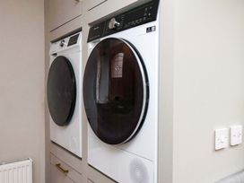 A laundry room with a washing machine and dryer at 59 Moorland Road Scarborough