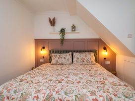 A bedroom with a bed and wall decorations at 59 Moorland Road, Scarborough