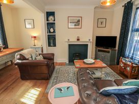 A living room with a sofa and television at 1 Albion Place Whitby