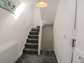 A hallway with a staircase and a door at 1 Albion Place in Whitby