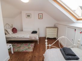 A bedroom with two beds and a dresser at 1 Albion Place in Whitby