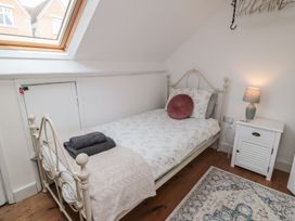 A bedroom with a bed and nightstand at 1 Albion Place in Whitby