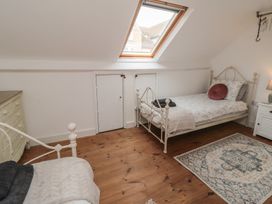 A bedroom with two beds and a wardrobe at 1 Albion Place Whitby
