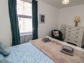 A bedroom with a bed and dressing table at 1 Albion Place in Whitby