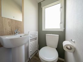 A bathroom with a toilet and wash basin at Billy’s Way - Hayling Island
