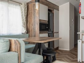 A dining area with a table and chairs at Wavecrest - Hayling Island Holiday Park
