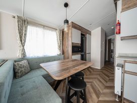 A dining area with a table and chairs at Wavecrest - Hayling Island Holiday Park