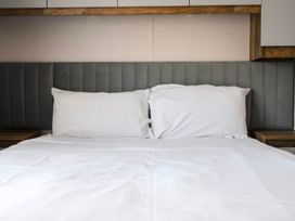 A bed with pillows and a headboard at Wavecrest - Hayling Island Holiday Park