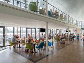 A restaurant with tables and chairs filled with people at Ripples & Reeds - Billing Aquadrome