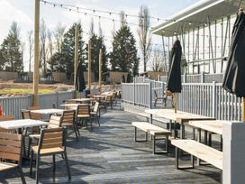 An outdoor seating area with tables and chairs at Waterslide Way - Billing Aquadrome