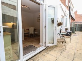A patio with a small table and two chairs outside a kitchen and dining area at 34 North Denes Road in Great Yarmouth