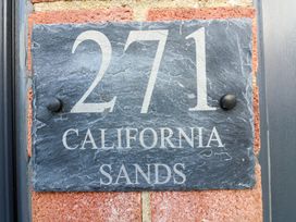 A house number plaque with the number 271 and text California Sands on a brick wall at 271 California Sands Estate California Norfolk
