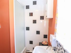 A bathroom with a shower cubicle sink soap dispenser and cabinet at 271 California Sands Estate in California Norfolk