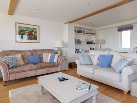 A living room with two sofas and a white coffee table at The Old Harbour Masters House in Fowey