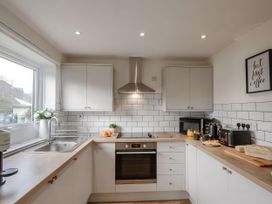 A kitchen with appliances and food items at Ty Golau in Llanbedrog