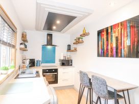 A kitchen with countertops stove oven microwave and two chairs at Orchard Retreat Staycation in Kirton