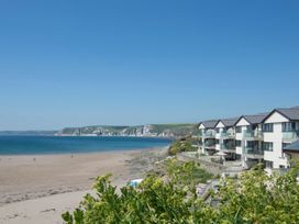 A beach with a building and ocean view at Apartment 12, Burgh Island Causeway Bigbury-On-Sea