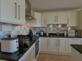 A kitchen featuring a sink, kettle, toaster, and storage container at Apartment 12, Burgh Island Causeway, Bigbury-On-Sea