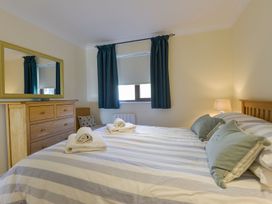 A bedroom with a bed and drawers at Apartment 12, Burgh Island Causeway Bigbury-On-Sea