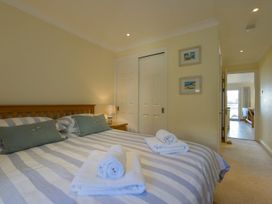 A bedroom with a bed and closet at Apartment 12, Burgh Island Causeway Bigbury-On-Sea