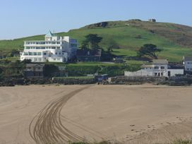 A beach with a building and hill in the background at Apartment 12, Burgh Island Causeway Bigbury-On-Sea