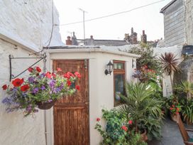 An outdoor area with a door and flowers at Springfield in Kingsand