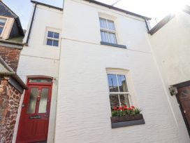 An exterior view of a white house with a red door and flower box at Springfield in Kingsand