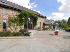 An outdoor area with a stone building and plants at Heathcliffe House in Castleton near Cardiff