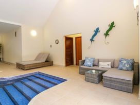 A living room with a jacuzzi and seating area at Heathcliffe House Caslteton near Cardiff