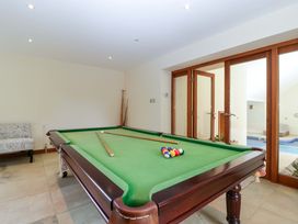 A game room with a pool table and sofa at Heathcliffe House in Castleton near Cardiff
