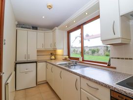 A kitchen with cabinets and a sink at Heathcliffe House in Castleton near Cardiff