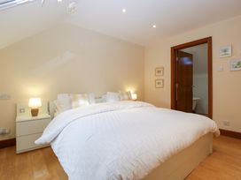 A bedroom with a bed and bedside table at Heathcliffe House in Castleton near Cardiff
