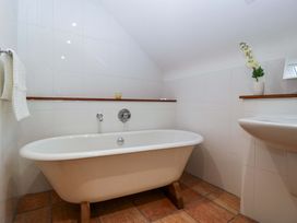 A bathroom with a bathtub and sink at Heathcliffe House Caslteton near Cardiff