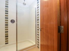A shower with glass door in a bathroom at Heathcliffe House Caslteton near Cardiff