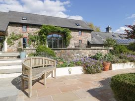An outdoor area with a bench and plants at Heathcliffe House in Castletown near Cardiff