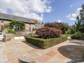 A garden area with trees and a house at Heathcliffe House Caslteton near Cardiff