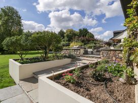 A garden with a pathway and seating area at Heathcliffe House in Castleton near Cardiff