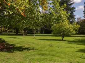 A garden with trees and grass at Heathcliffe House Caslteton near Cardiff