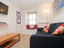 A living room with a television and sofa at 23 Carncrows Street St Ives