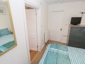 A bedroom with a bed and mirror at 23 Carncrows Street St Ives