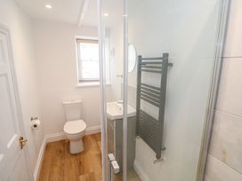 A bathroom with a shower, sink, and toilet at 23 Carncrows Street St Ives