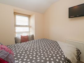 A bedroom with a bed and a television at 23 Carncrows Street St Ives