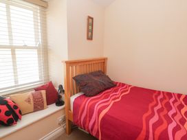 A bedroom with a bed and pillows at 23 Carncrows Street St Ives