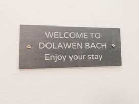 A wall sign with the text Welcome to Dolawen Bach Enjoy your stay at Dolawen Bach in Conwy