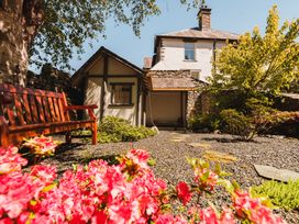 A garden with a bench and flowers at Leathes Head Country House Borrowdale near Keswick