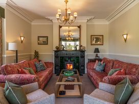 A living room with sofas and a fireplace at Leathes Head Country House in Borrowdale near Keswick