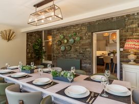 A dining room with a long table set for a meal at Leathes Head Country House Borrowdale near Keswick
