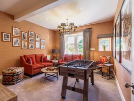 A living room with a foosball table and seating area at Leathes Head Country House in Borrowdale near Keswick