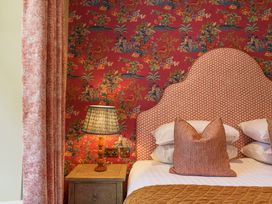 A bedroom with a bed, pillows, and a lamp at Leathes Head Country House Borrowdale near Keswick